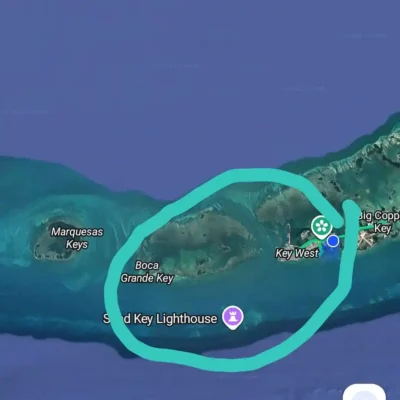 A digital map screenshot shows the Florida Keys, highlighting Key West, Boca Grande Key, and Sand Key Lighthouse with a teal circle—perfect for planning your next excursion.